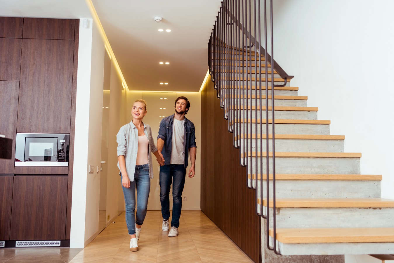 Couple admiring their modern floating staircase in a contemporary Australian home interior