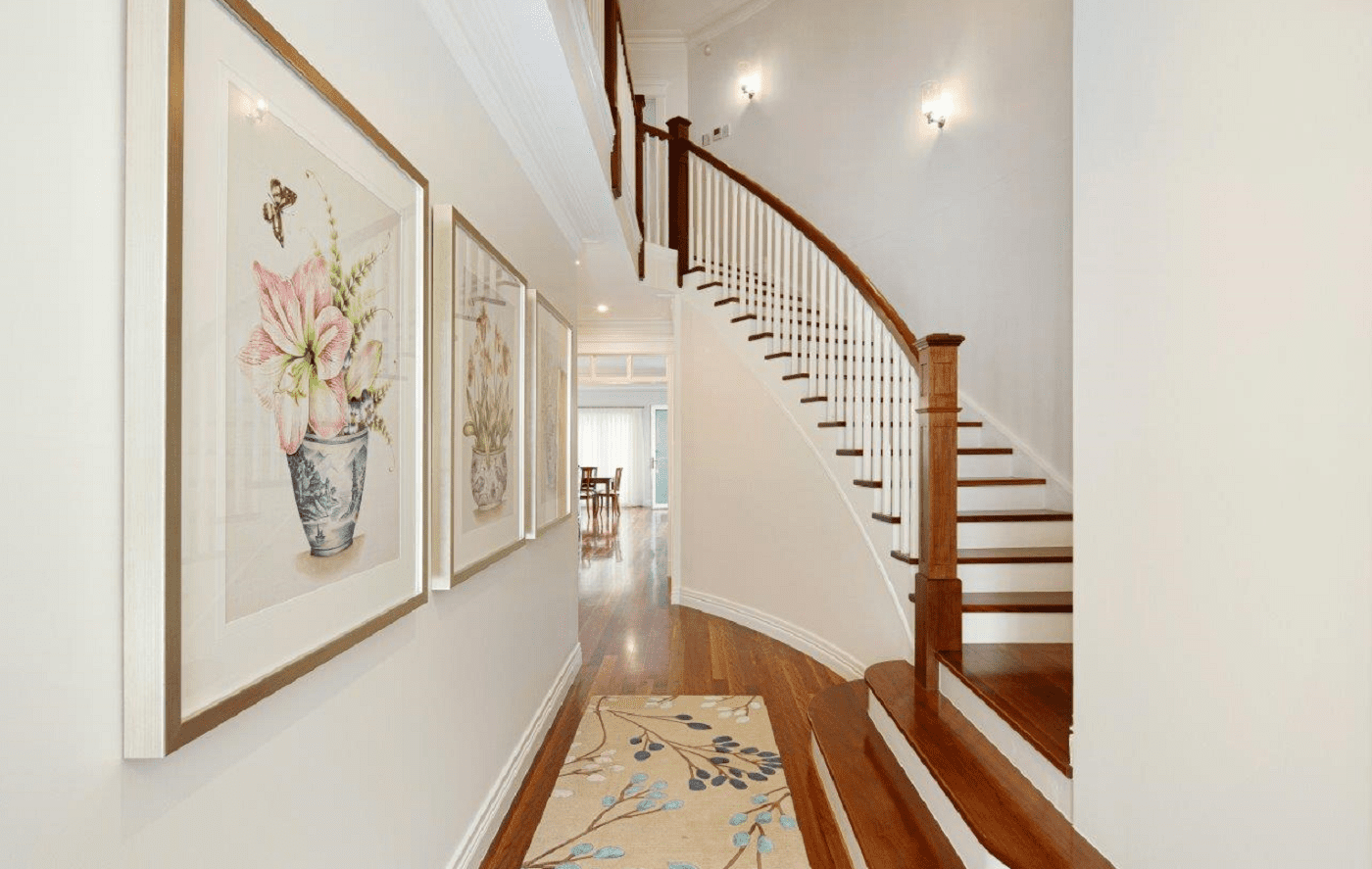 Curved hardwood staircase in an elegant hallway showcasing Australian timber species