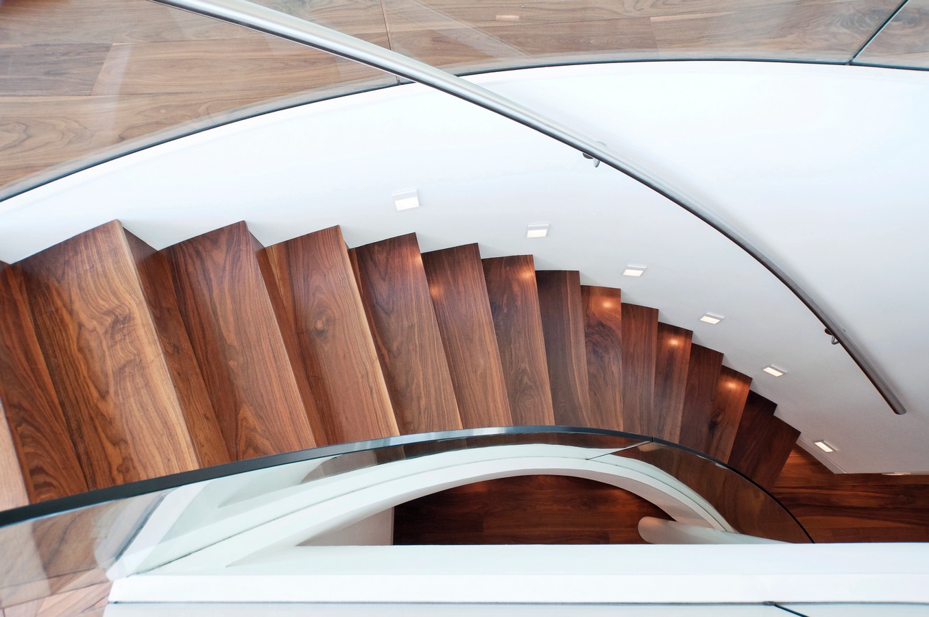 Elegant curved timber staircase with sweeping handrail in a Brisbane home