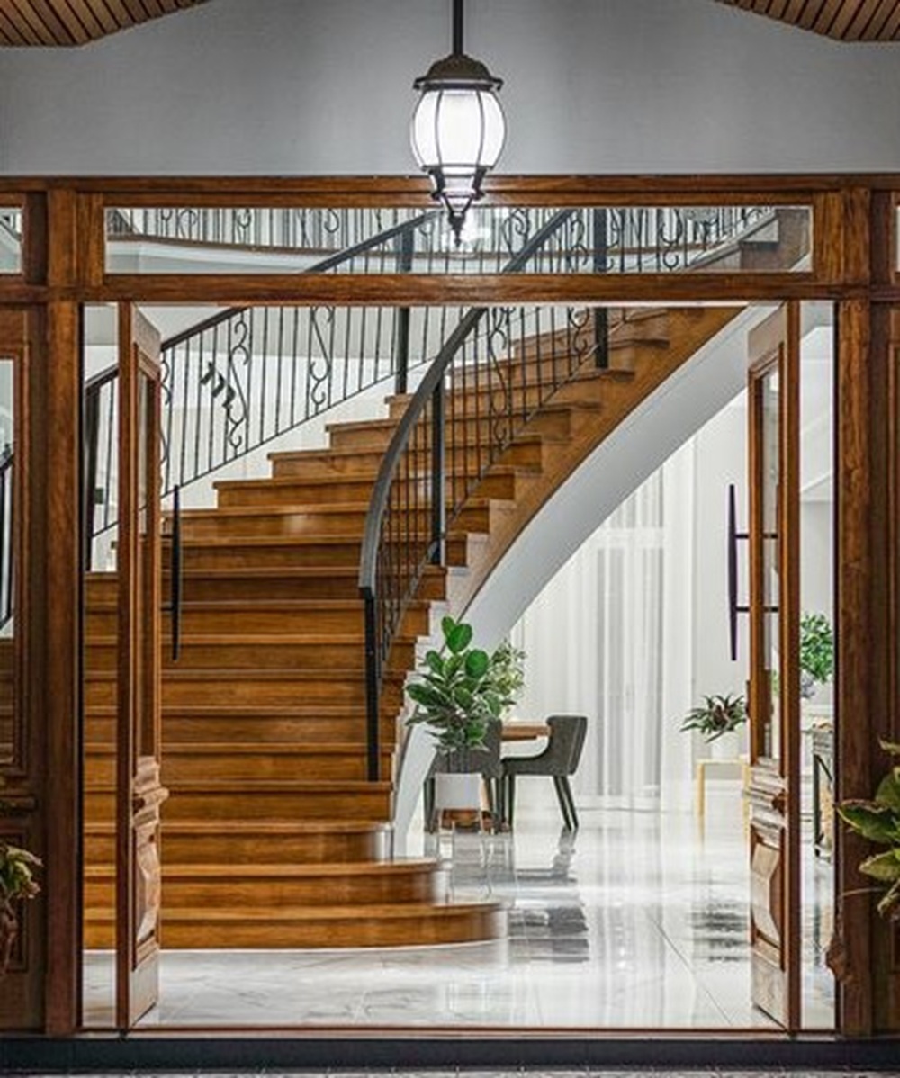 Grand curved staircase viewed through a doorway