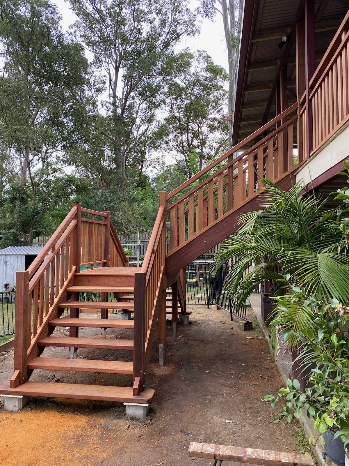 External wooden staircase on a raised Queensland home with hardwood treads and balustrade
