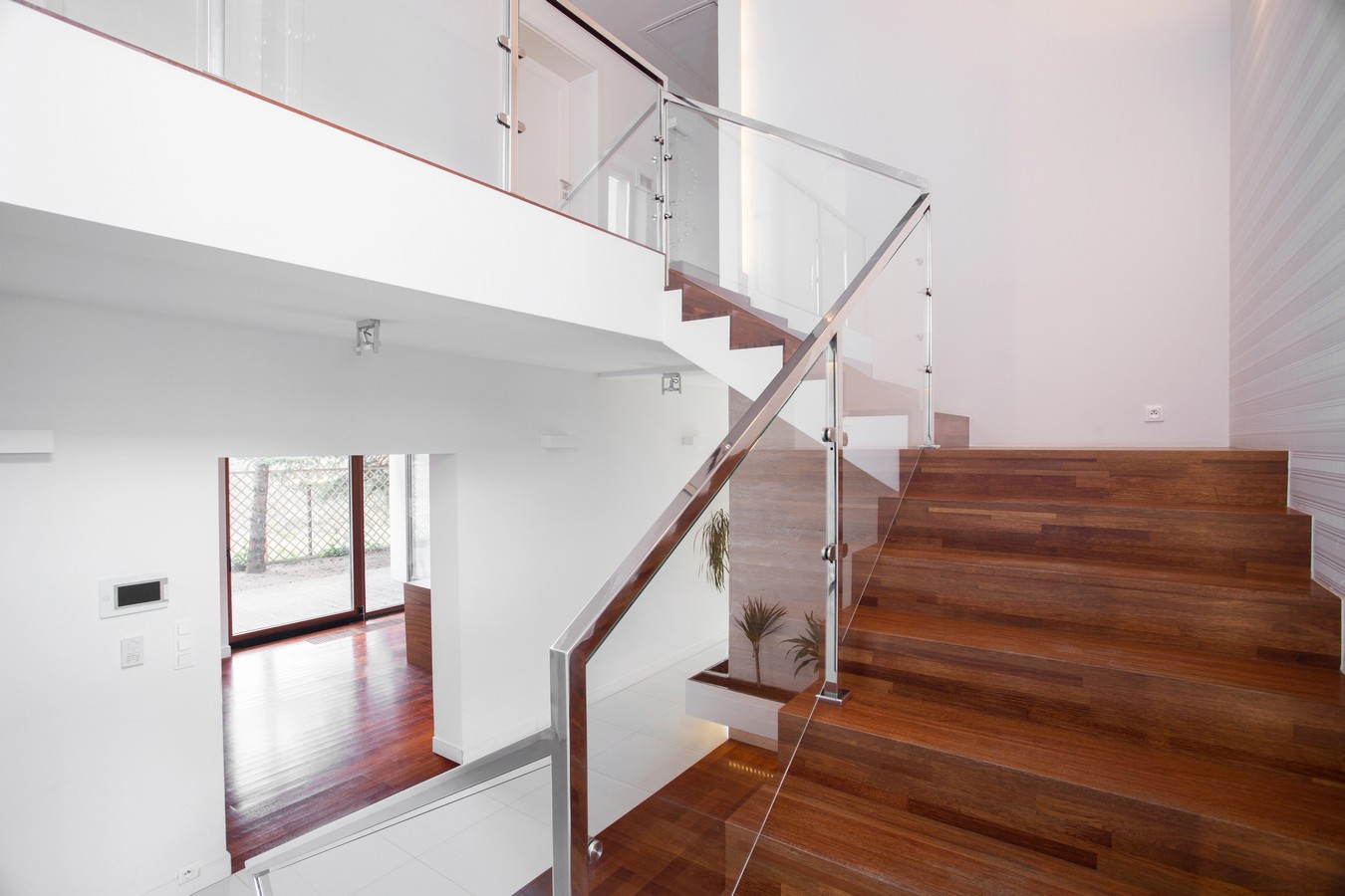 Hardwood staircase with frameless glass balustrade in a contemporary Queensland home