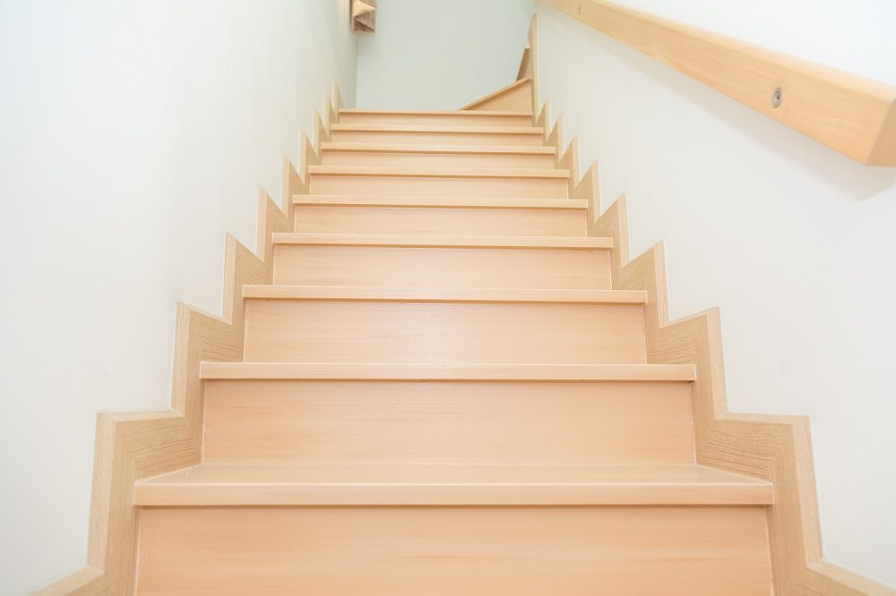 Straight flight staircase showing individual timber risers and treads in a residential home