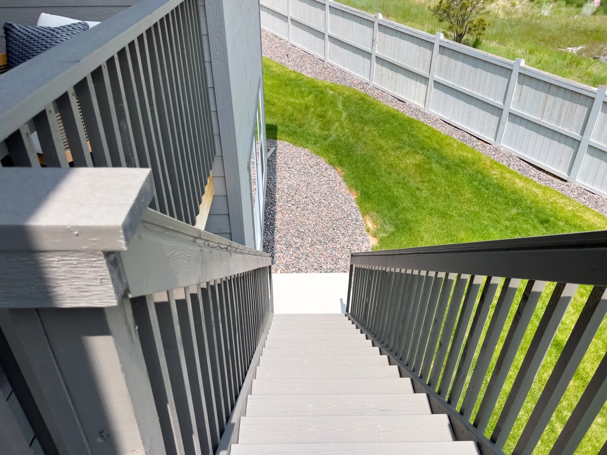 Outdoor deck stairs with grey balustrade on a Queensland home exterior