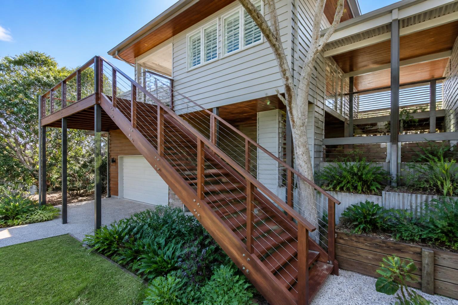 Outdoor hardwood staircase built by a QBCC-licensed Brisbane staircase builder on a contemporary Queenslander home