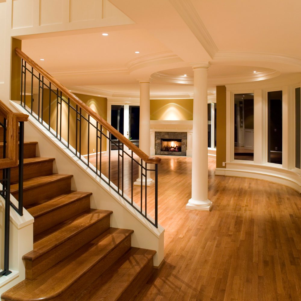 Custom timber handrail on internal staircase in Brisbane home with wrought iron balusters
