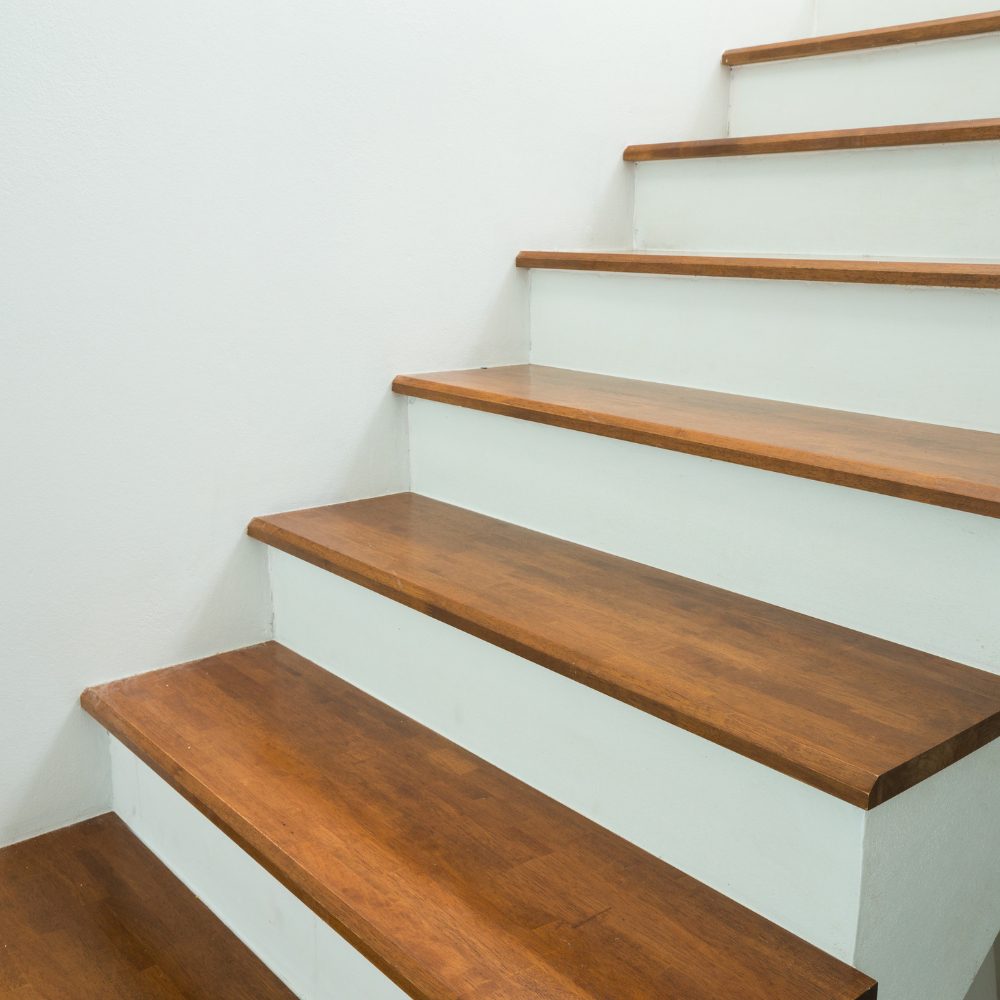 Stylish staircase railing combining timber handrail and glass panels in a Moreton Bay home