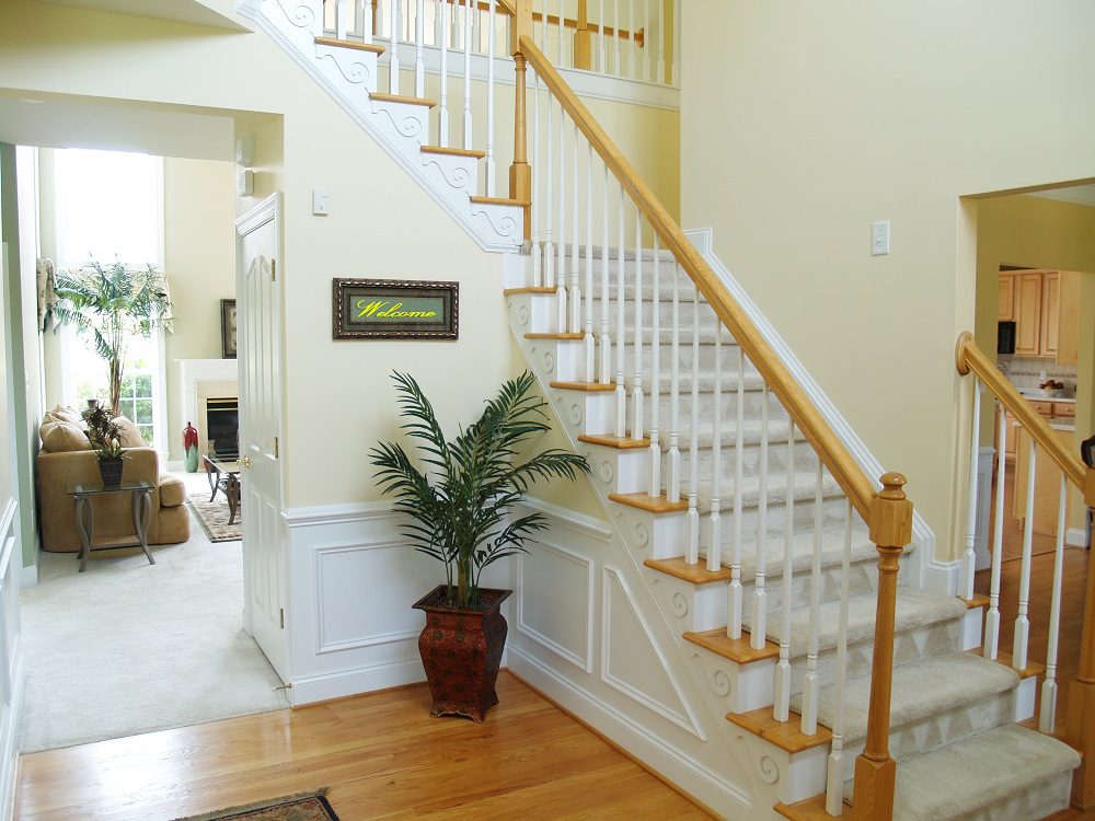 Quarter-turn L-shaped staircase with hardwood treads and timber balustrade in a Brisbane home